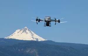 A DJI T30 agricultural drone flies a reseeding mission in Wasco County, Oregon