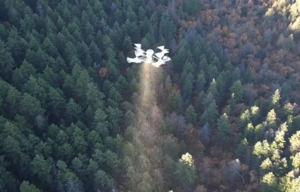 A drone flying for broadcast seeding
